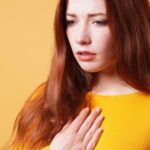 sad young woman with hand on chest feeling sick fr 2022 11 16 17 06 51 utc 900x370 1